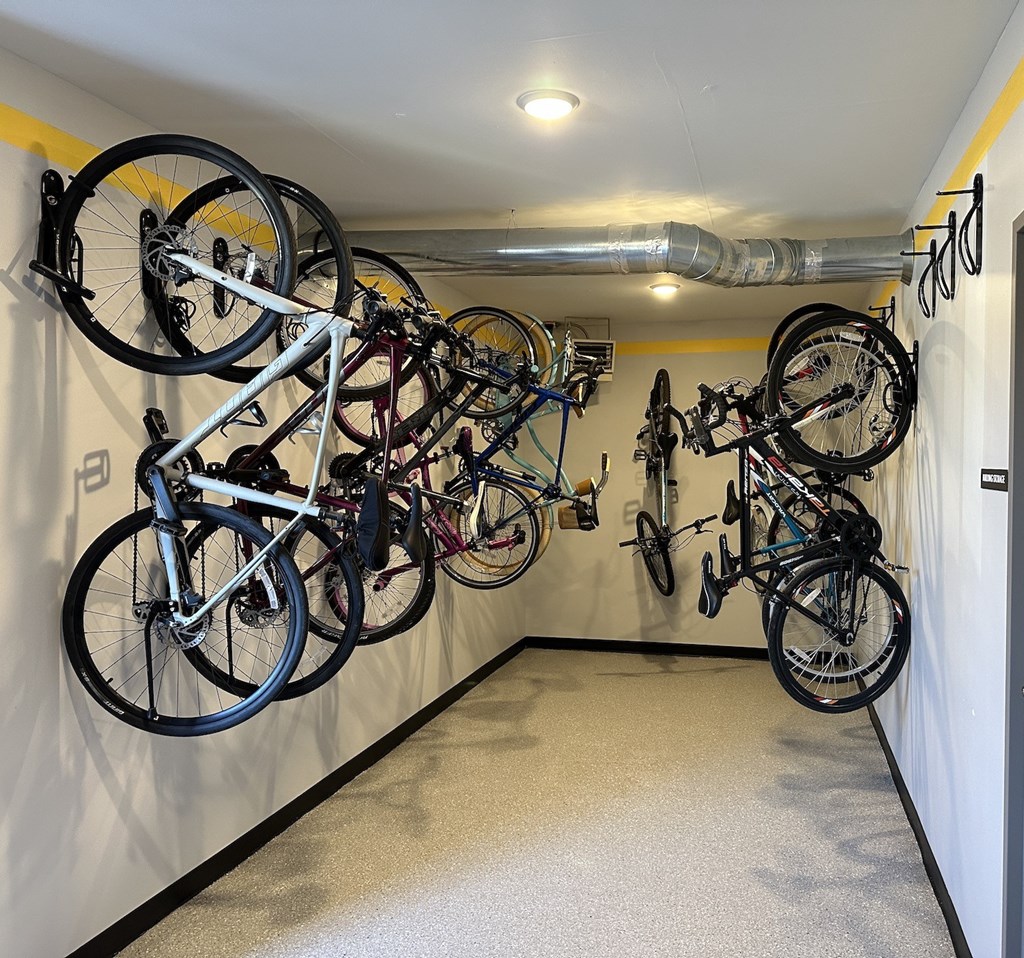 a row of bikes hanging on a wall in a garage